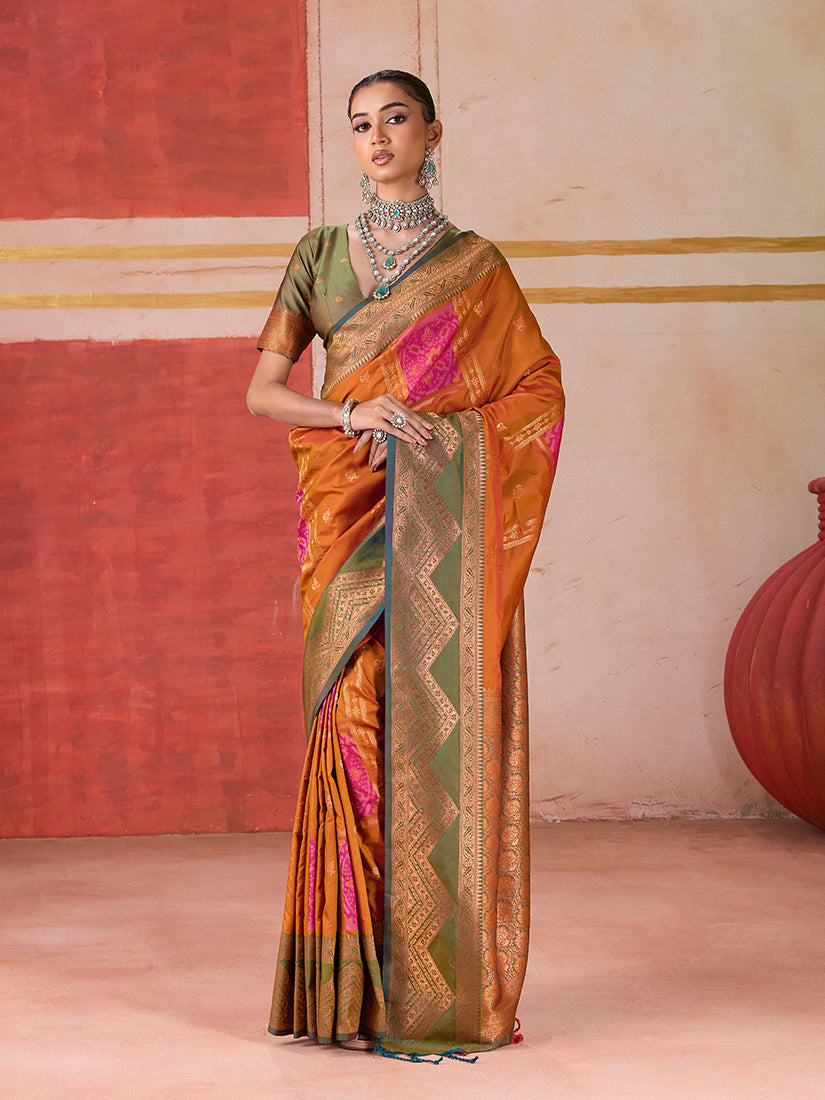 Orange silk blend traditional saree featuring ornate woven work and a luxurious sheen