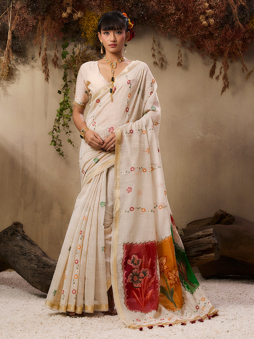 Woman wearing a cream colored handloom cotton blend woven saree with traditional ethnic patterns