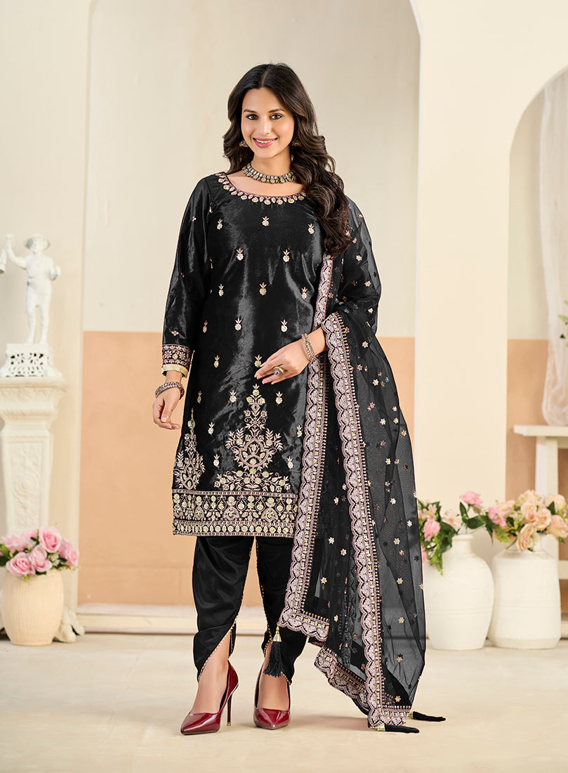 Model wearing a black velvet patiala salwar kameez with detailed sequins and resham embroidery