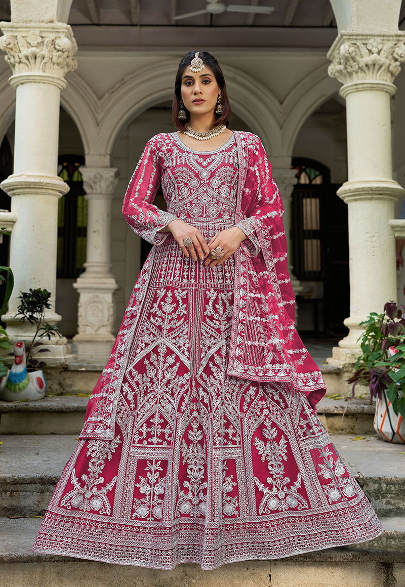 A front view of a vibrant Rani Pink embroidered net gown with an elegant dupatta set.