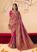 Traditional Rani Pink silk blend saree with detailed cutwork embroidery and a delicate lace border.