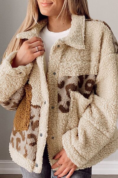 A woman wearing a cozy beige and brown leopard print sherpa jacket with a collared neck and functional pockets.