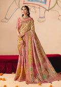 Model wearing a glamorous multicolor silk blend saree with intricate embroidery and a fitted gold and pink blouse.