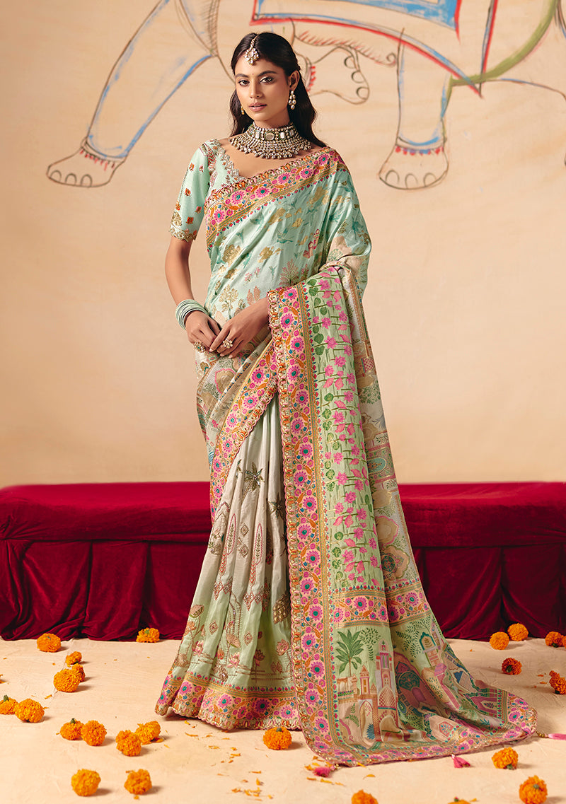 Aqua blue silk blend saree featuring ornate embroidery and cutwork borders