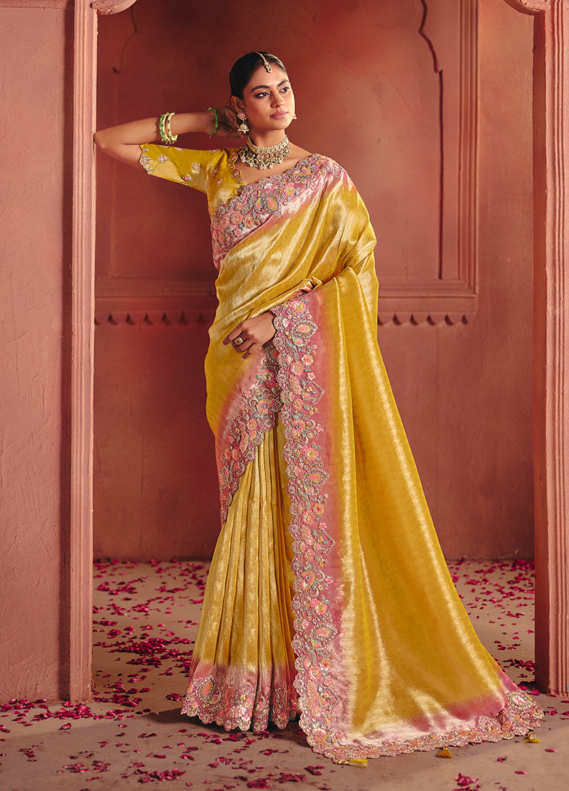 Model wearing a vibrant yellow silk blend saree with intricate sequin and thread embroidery