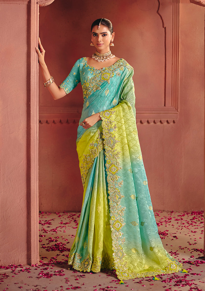 Close up of turquoise and lime green silk jacquard saree with metallic embroidery and sequins