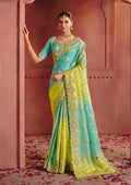 Close up of turquoise and lime green silk jacquard saree with metallic embroidery and sequins