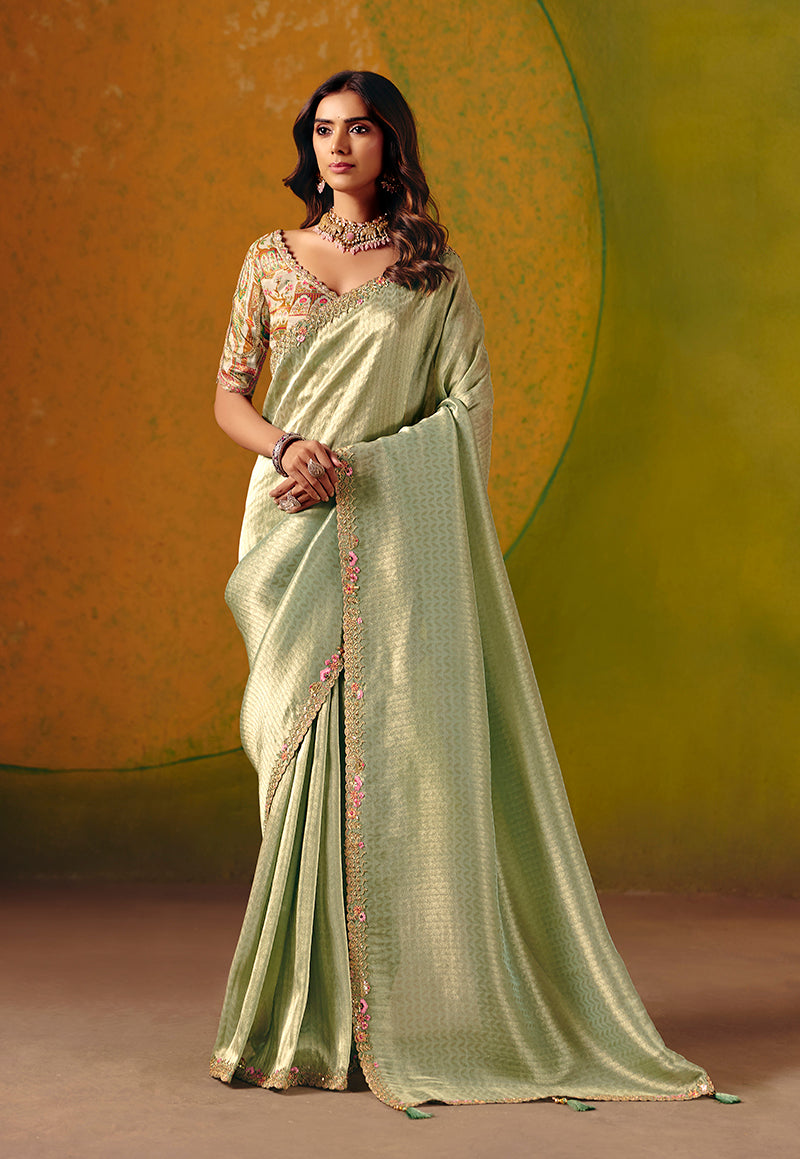 Monjolika Fashion Pista Green silk blend saree with intricate embroidery and sequin detail.
