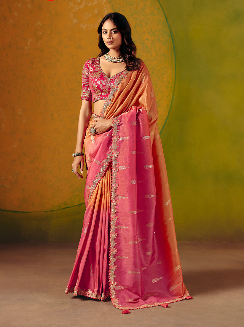 A beautiful Rani Pink and Peach silk blend saree featuring intricate embroidery and sequin work.