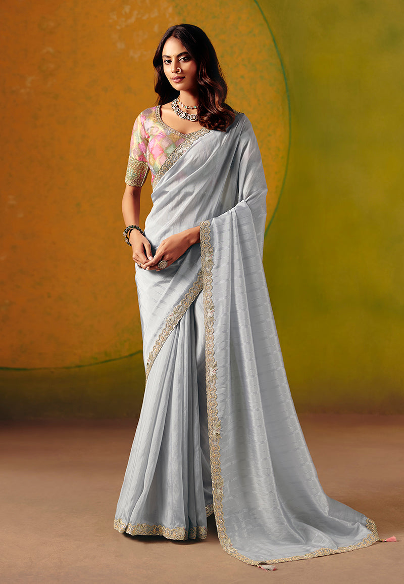 Light grey silk blend saree with intricate embroidery and sequin work.