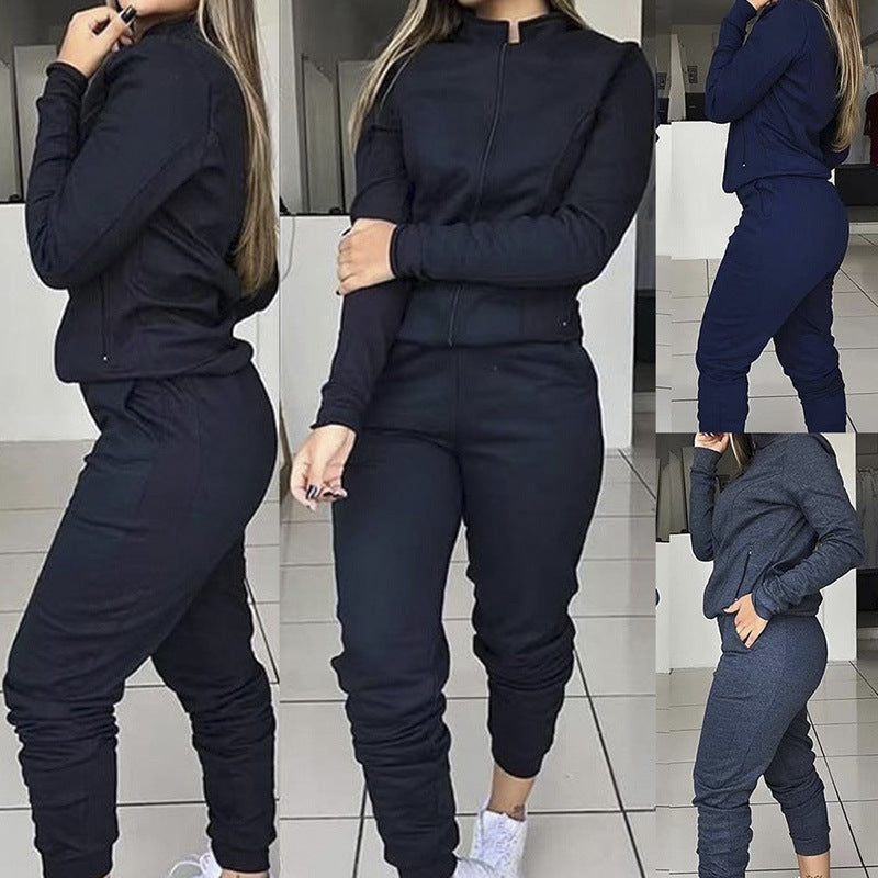 Model wearing a navy blue two-piece casual zip-up jacket and jogger pant set.