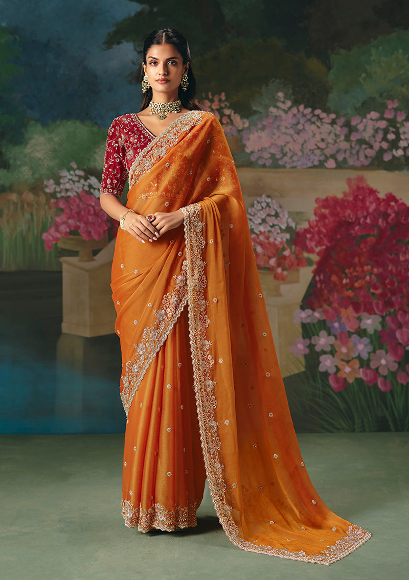 Orange fancy fabric saree featuring detailed beadwork and sequins