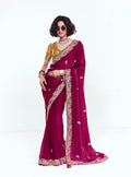 Rani pink fancy fabric saree featuring an embroidered border and sequins