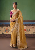 Vibrant mustard embroidered fancy fabric saree for festive occasions.
