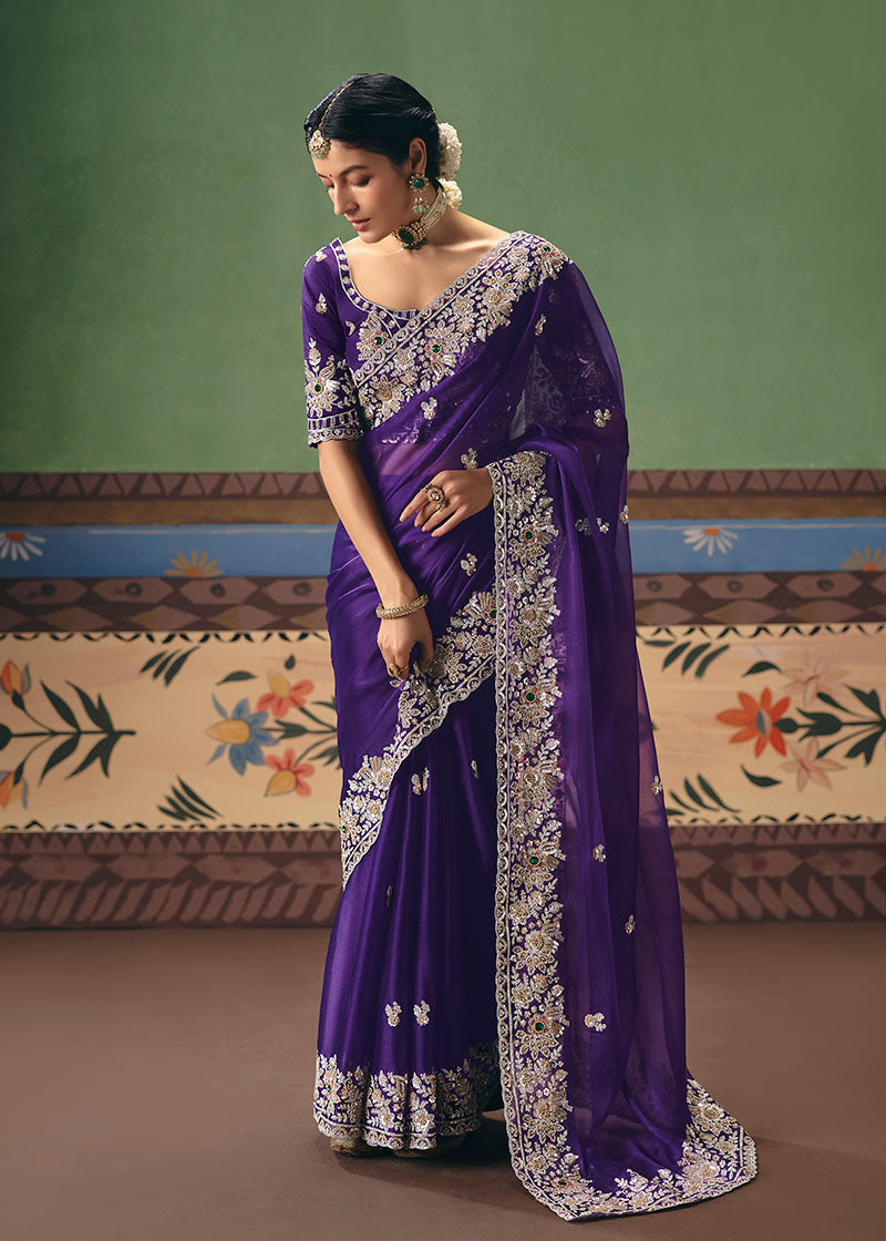 A majestic purple fancy fabric saree featuring intricate embroidery.