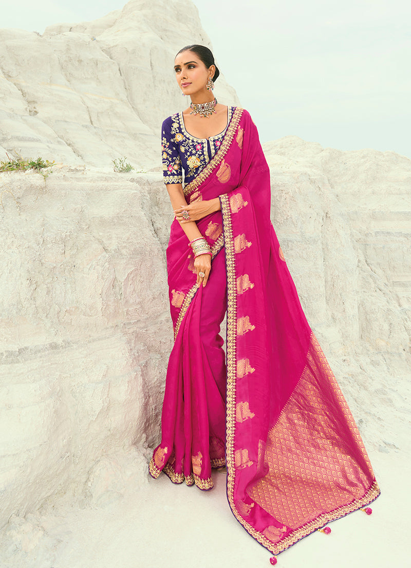 Vibrant rani pink saree crafted from organza, satin, and viscose with embroidery