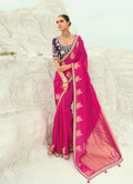 Vibrant rani pink saree crafted from organza, satin, and viscose with embroidery