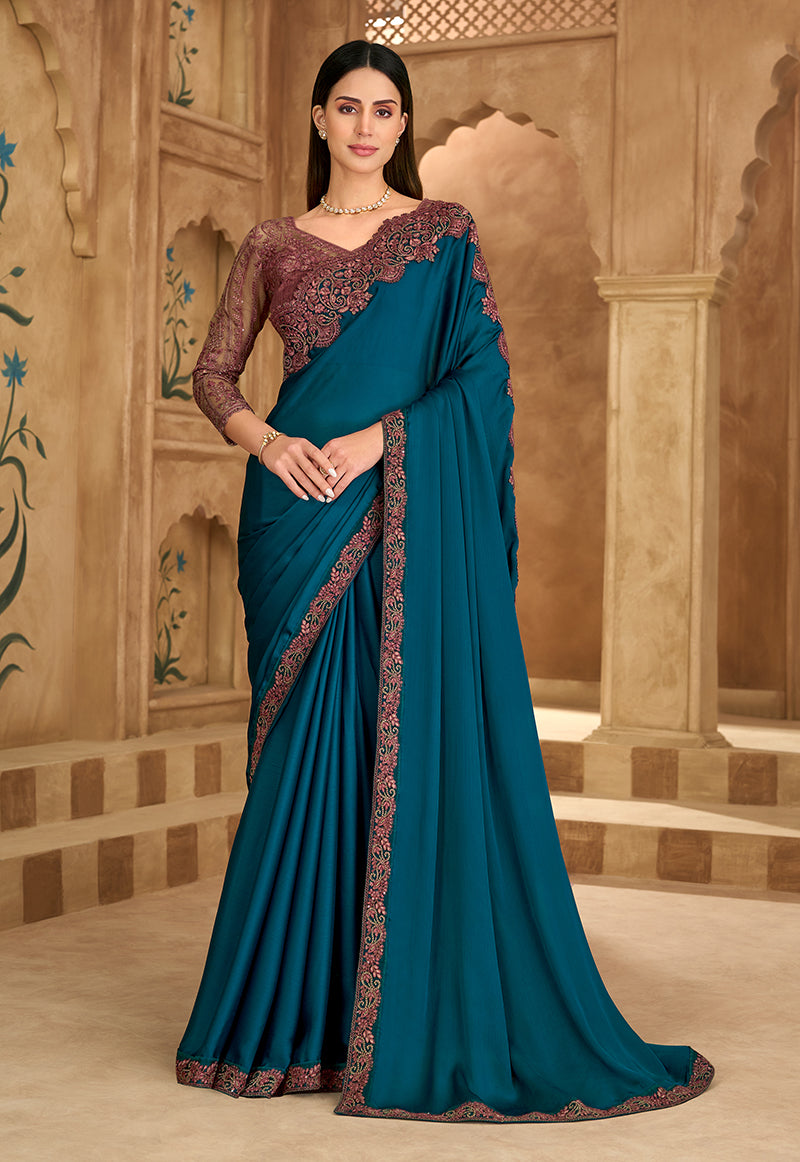 Teal blue faux chiffon satin saree with intricate embroidery and unstitched blouse