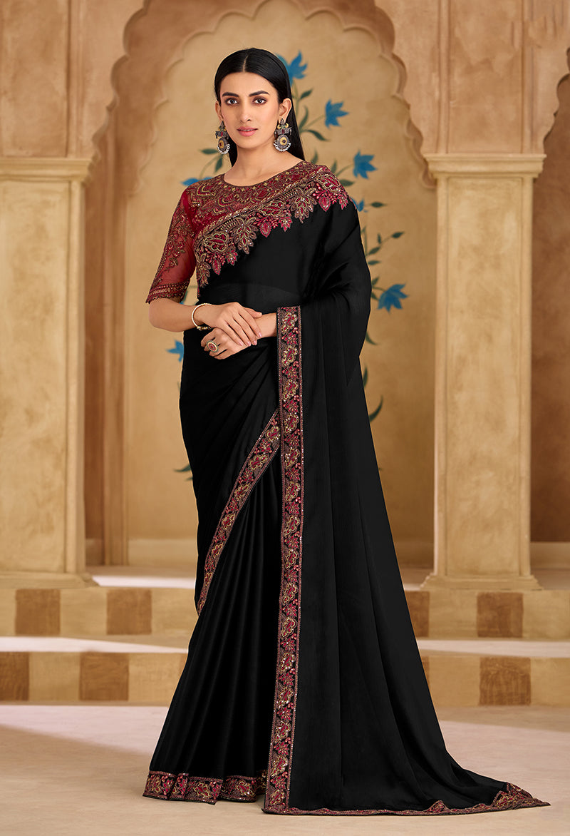 A black faux georgette saree with detailed embroidery and border work.