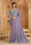 Lavender faux chiffon saree with intricate border embroidery and unstitched blouse piece.