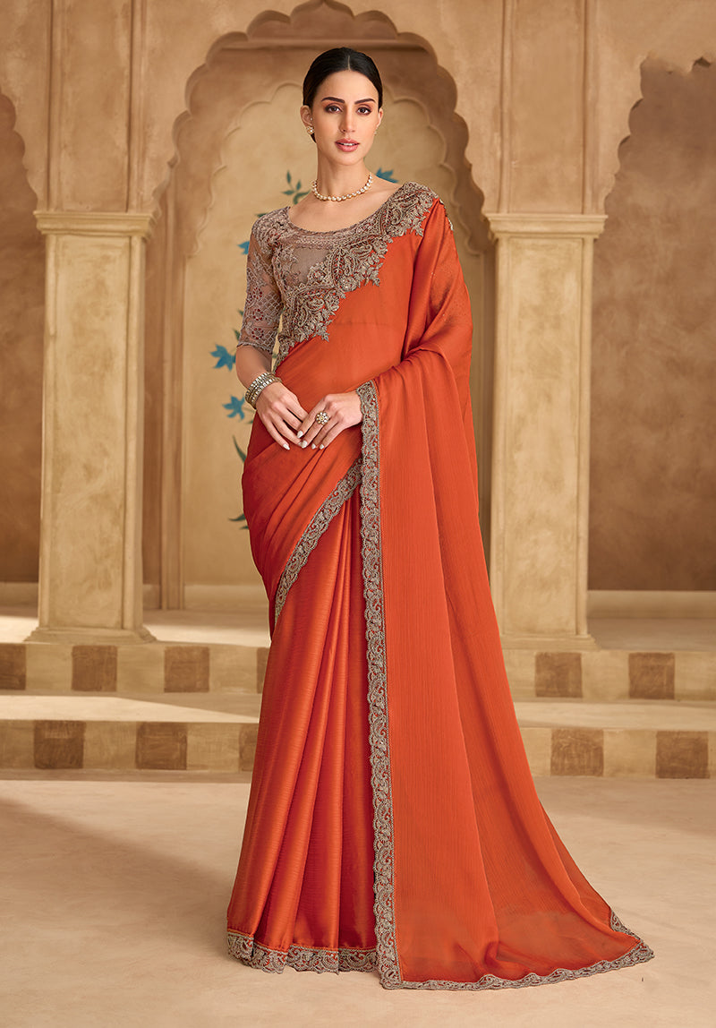 Vibrant orange faux chiffon and satin saree with embroidered border