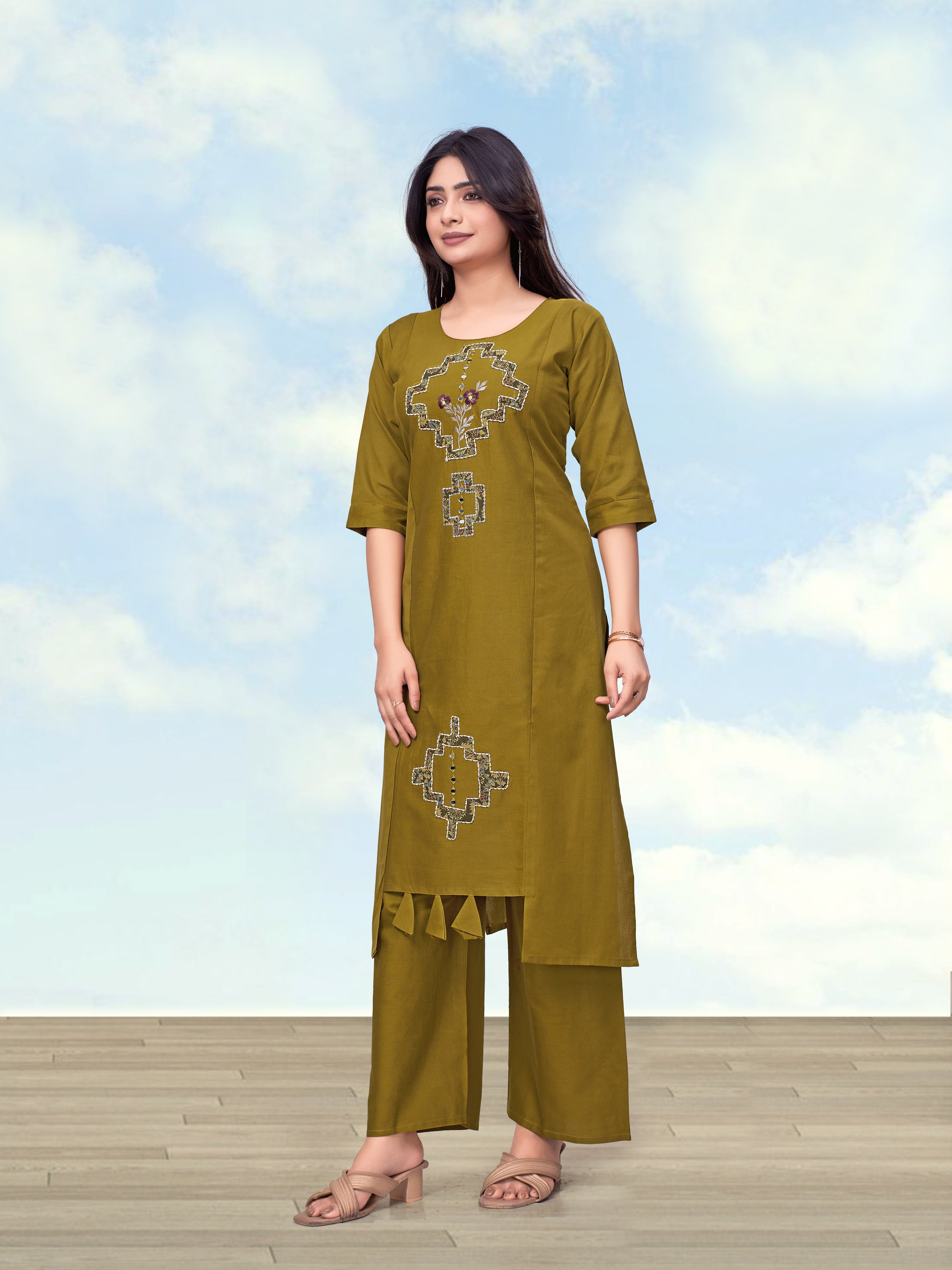 Woman wearing an olive green straight cotton flex kurti with embroidered floral details paired with matching pants.