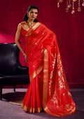 Red satin linen silk saree with woven gold motifs and temple border