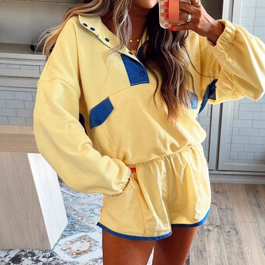 Woman wearing a yellow and blue contrast long-sleeve pullover top and matching shorts set.