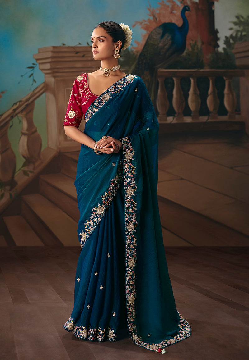 Teal blue fancy fabric saree featuring elegant embroidered detailing