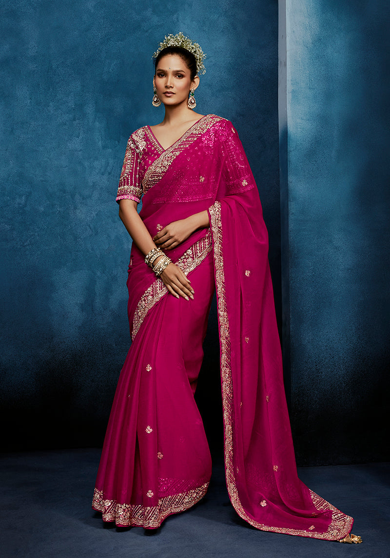 Rani pink embroidered fancy fabric saree with matching stitched blouse