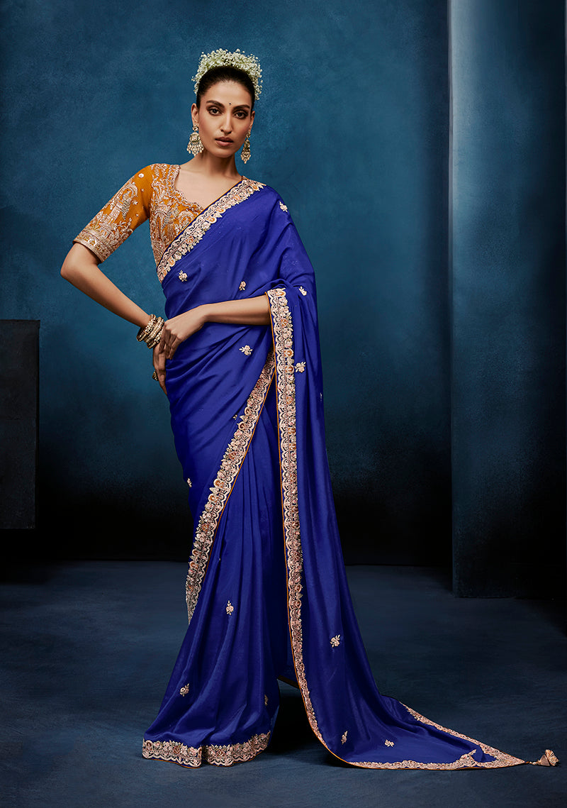 Royal Blue fancy fabric saree with detailed border and stitched blouse