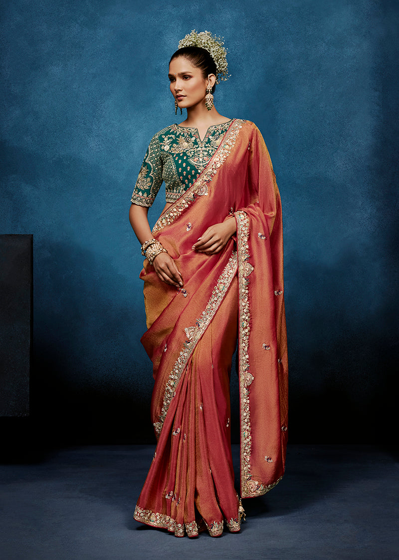 Rust colored fancy fabric saree with embroidered border and included stitched blouse