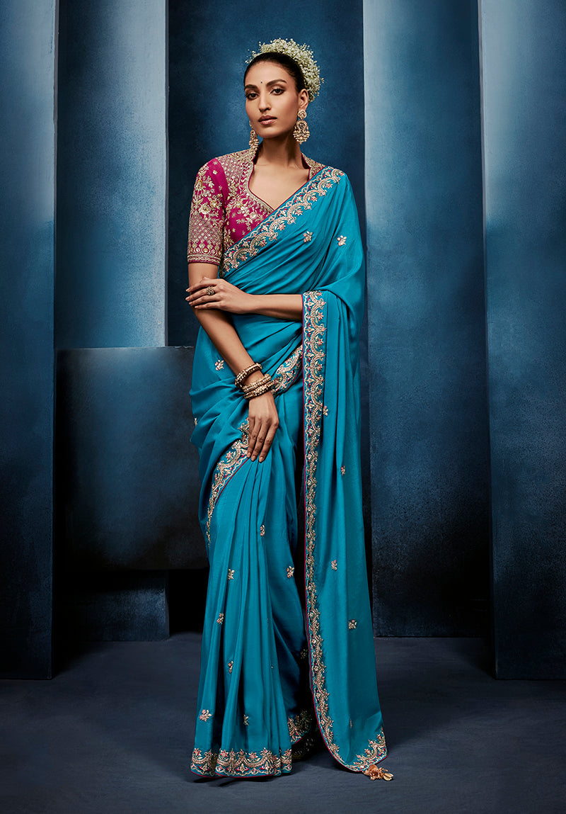Aqua blue fancy fabric saree with embroidery detail and stitched blouse