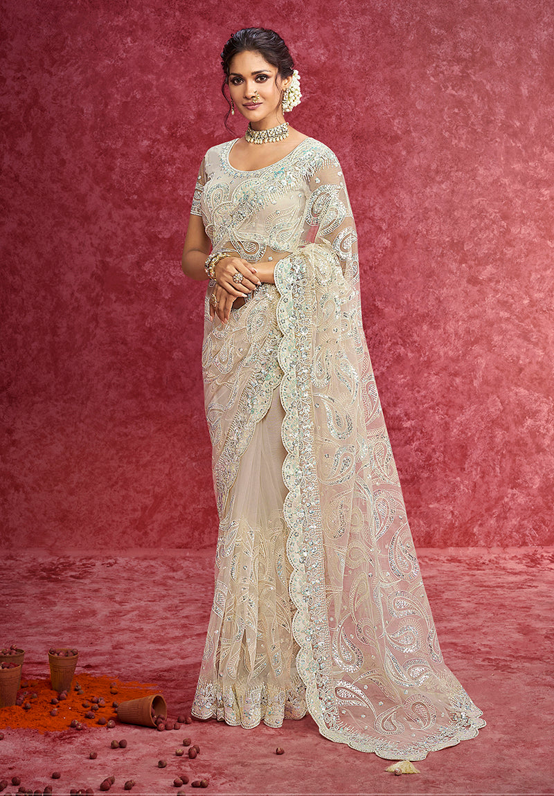Elegant off white net saree with sequins, zari, and thread embroidery on a scalloped border