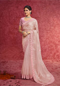 Baby girl wearing an elegant baby pink faux tissue embroidered saree with sequin detailing and a scalloped border.