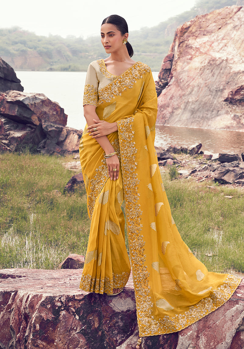 Yellow faux tissue silk saree featuring sequin and khatli work embroidery.
