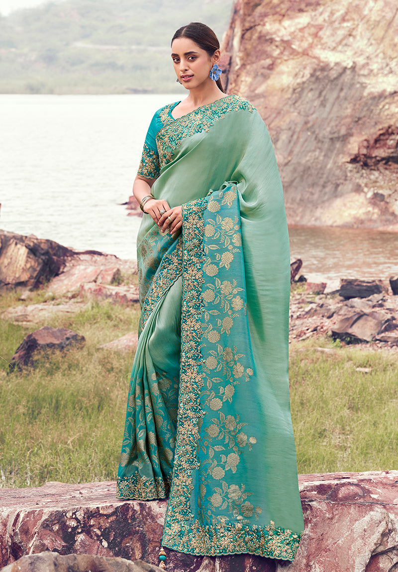 Sea green and aqua blue faux tissue silk saree with intricate embroidery and sequin work.