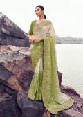 Beige and green faux tissue silk saree with intricate embroidery and sequin embellishments.