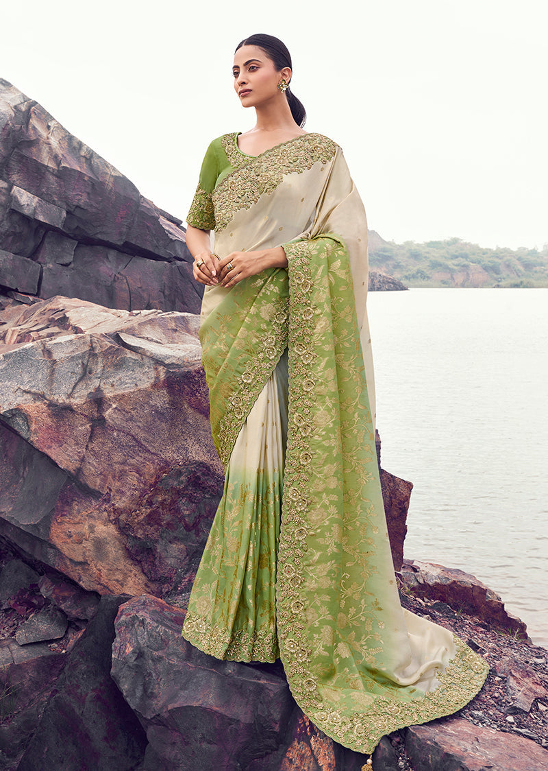 Beige and green faux tissue silk saree with intricate embroidery and sequin embellishments.
