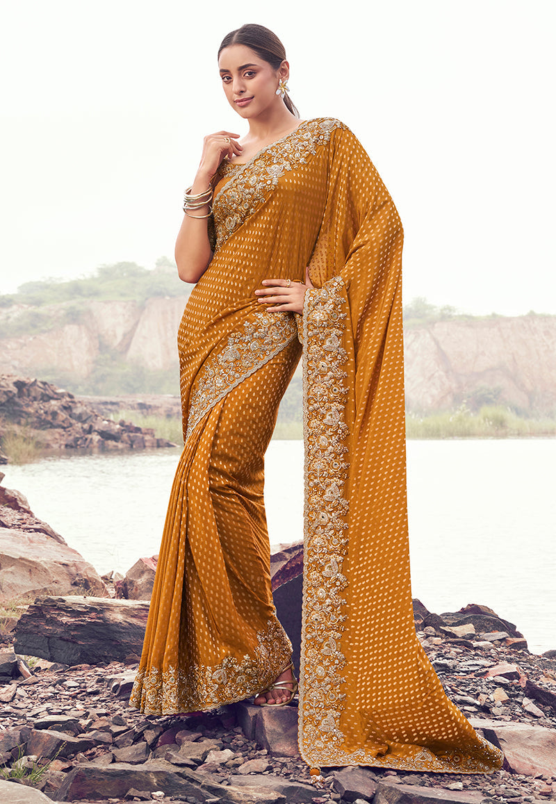 Rust orange satin silk saree with intricate embroidery and sequin embellishments