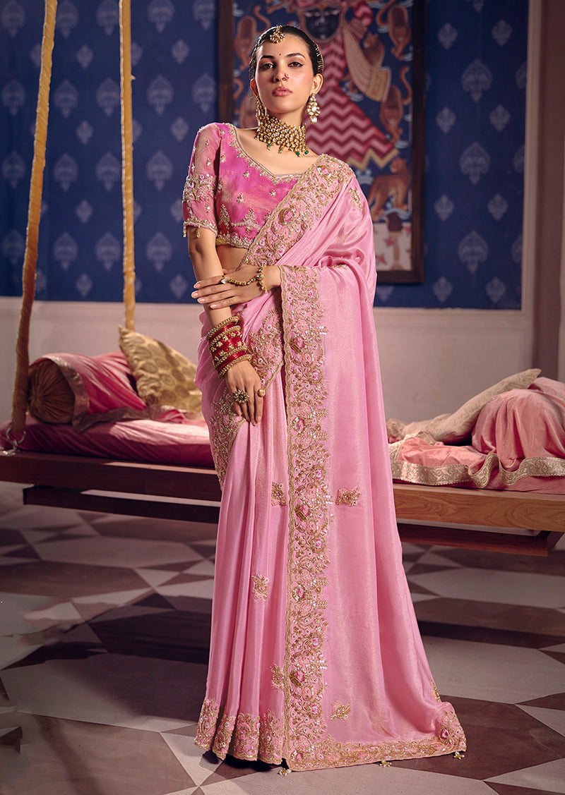 Pink viscose zari tissue silk saree with intricate embroidery and a graceful fall.