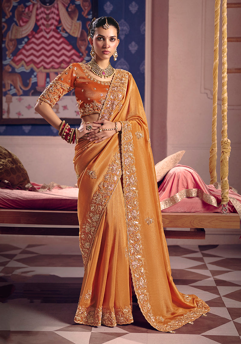 Orange viscose tissue silk saree with intricate zari embroidery