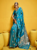 Aqua blue satin silk saree featuring traditional handloom weaving and a delicate gold zari border