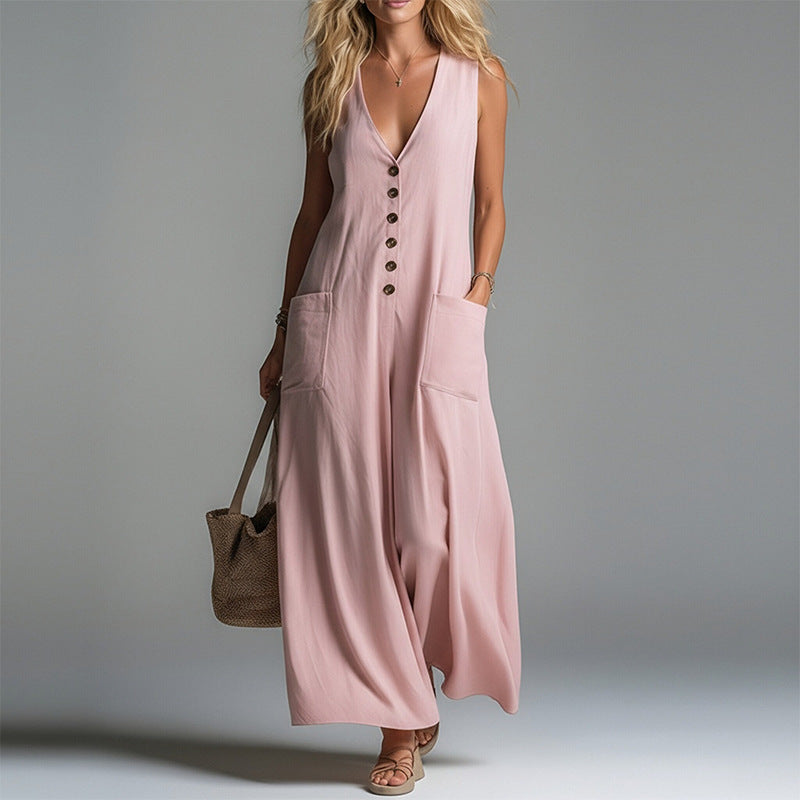 A woman wearing a flowing V-neck sleeveless maxi dress with a button-up front and large side pockets.