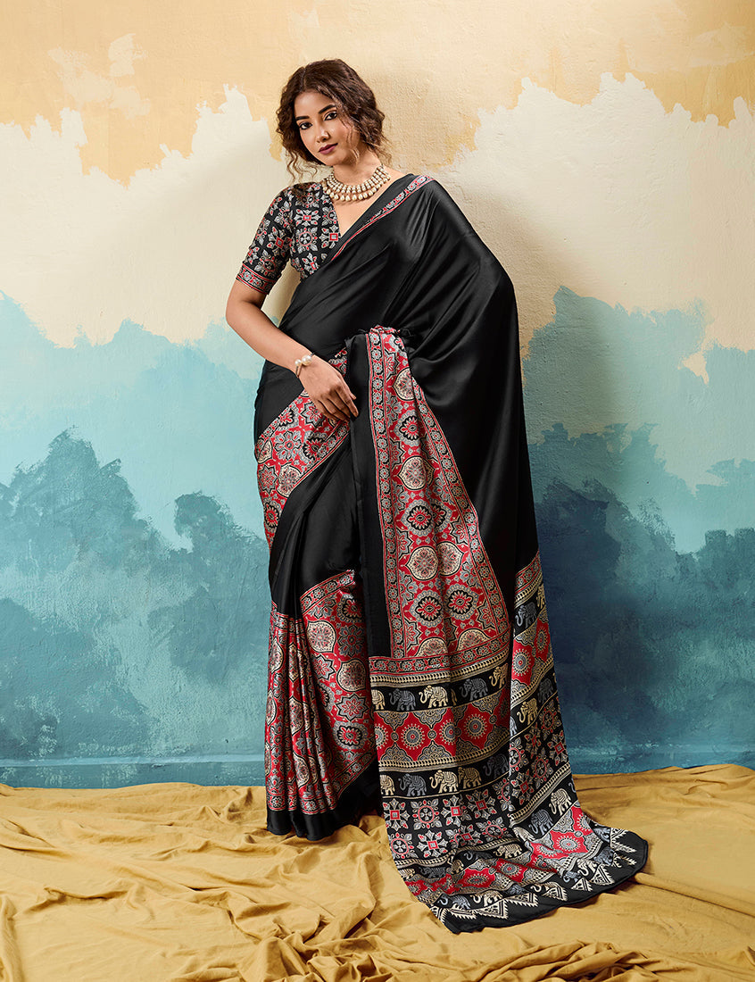 Black modal satin saree featuring detailed ethnic Ajrakh motifs and a silky finish