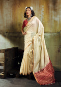 Classic cream faux tussar silk saree with ornate golden zari woven pallu