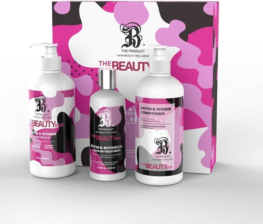 B THE PRODUCT Biotin shampoo, conditioner, and leave-in treatment bottles in pink, black, and white abstract print.