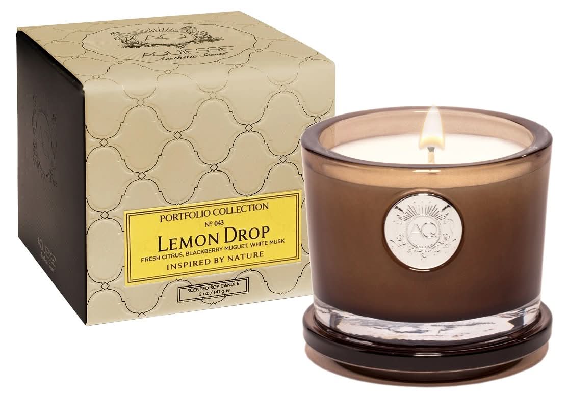 Lemon Drop scented candle in a heavy-walled smoky brown glass vessel with cream and yellow packaging accents