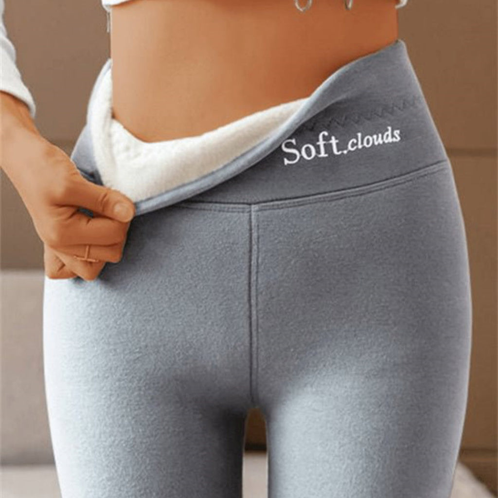 A pair of high-waist fleece-lined shark leggings in grey, showcasing the soft white fleece interior and the smooth sculpted outer fabric.