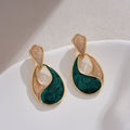 Elegant blue water drop stud earrings in a classic teardrop design, styled with a sophisticated French aesthetic.